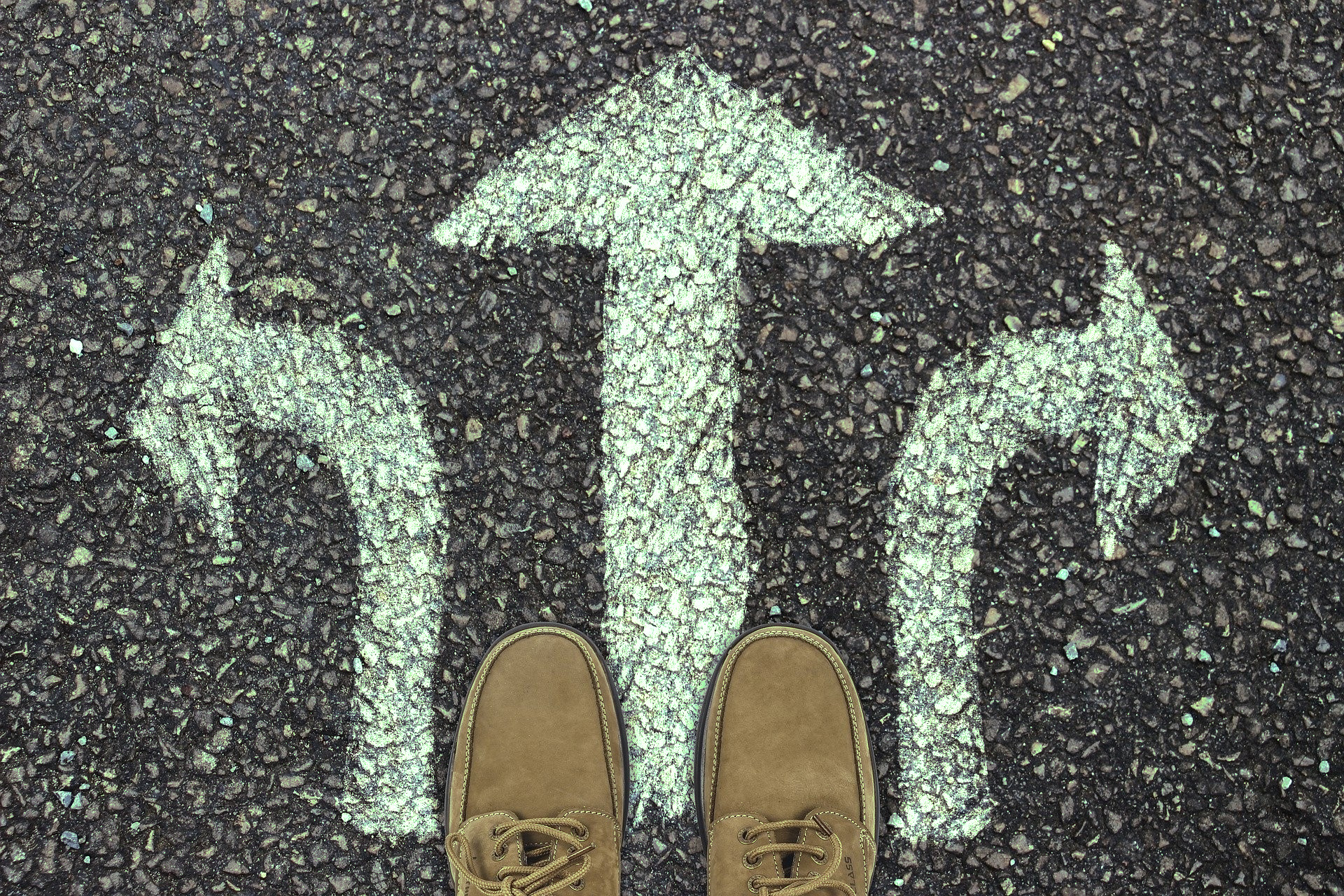 Shoes stand in front of direction arrows